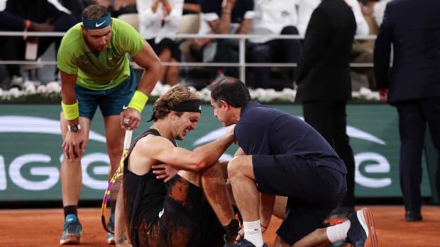 Rafael Nadal checks on Alexander Zverev after injury