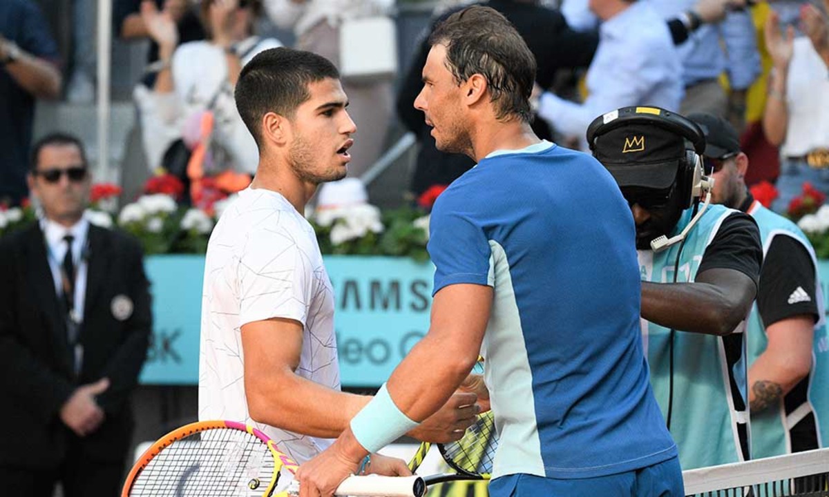 Carlos Alcaraz and Rafael Nadal at the net in Madrid
