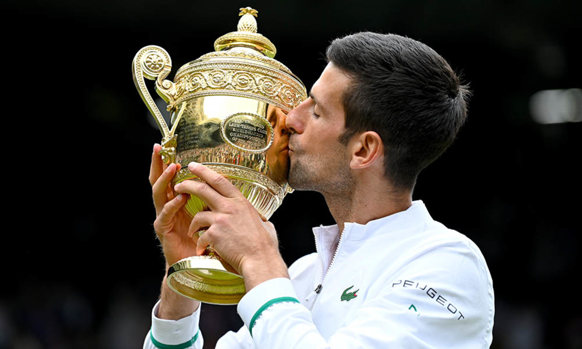 Novak Djokovic kissing Wimbledon trophy 2021