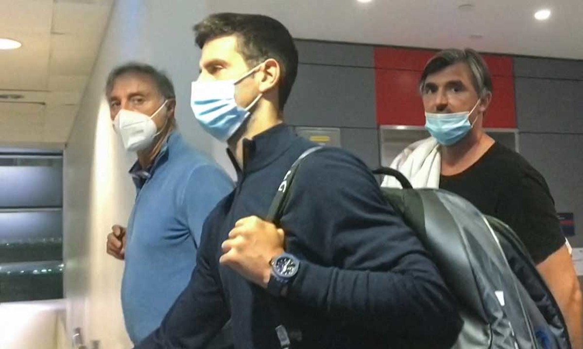 Novak Djokovic being escorted out of Australia